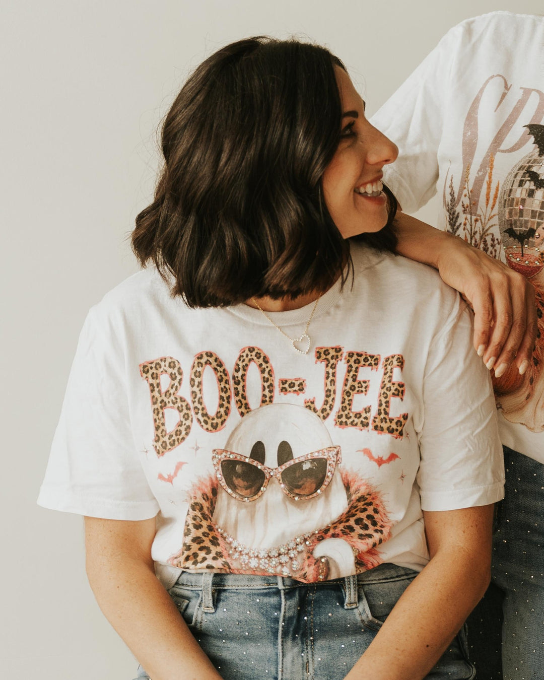 BOO JEE Bling T in white with leopard BOO-JEE lettering and a ghost in rhinestone sunglasses and pearls, worn with rhinestone jeans