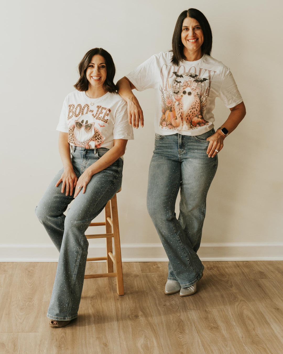 Full-length view of the Spooky Ghost Purse Pink Boa Bling T styled with rhinestone jeans and sparkly boots, shown alongside the BOO JEE Bling T