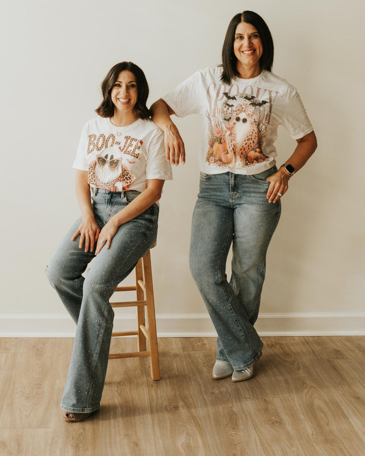 Full-length view of the Spooky Ghost Purse Pink Boa Bling T styled with rhinestone jeans and sparkly boots, shown alongside the BOO JEE Bling T